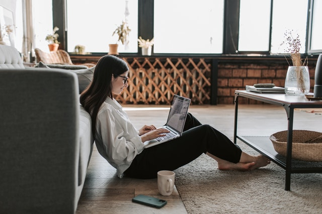 a woman sitting at a table using a laptop